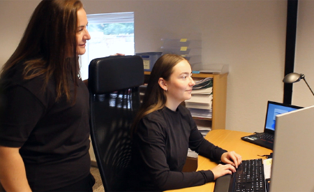 Two Global Boiler team members collaborating in the office on spare parts inquiries